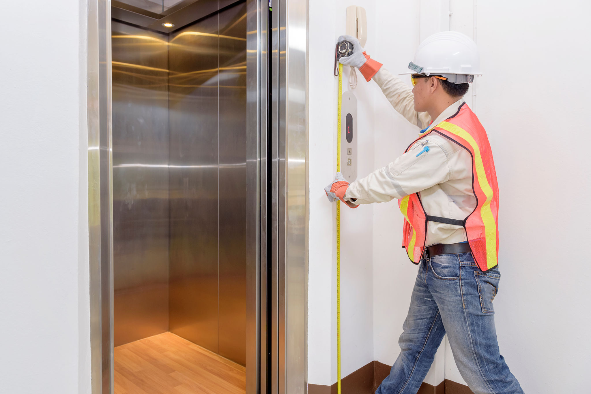 Technician - Engineer investigate work adjustment mechanism lifts the elevator.
